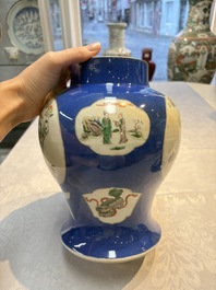 Two Chinese famille verte blue-ground vases and covers, 19th C.