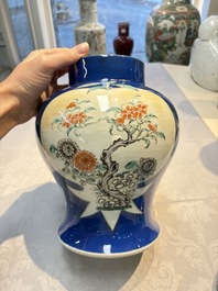 Two Chinese famille verte blue-ground vases and covers, 19th C.
