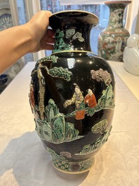 An unusual Chinese famille noire vase with relief design, Kangxi mark, 19th C.