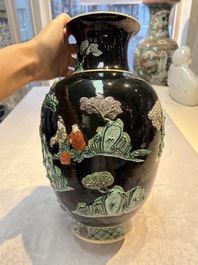An unusual Chinese famille noire vase with relief design, Kangxi mark, 19th C.