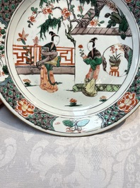 A pair of Chinese famille verte 'Ladies in a Garden' plates, Kangxi