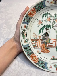 A pair of Chinese famille verte 'Ladies in a Garden' plates, Kangxi