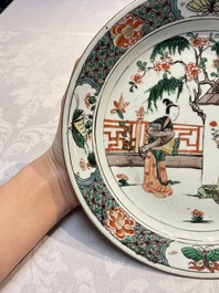 A pair of Chinese famille verte 'Ladies in a Garden' plates, Kangxi