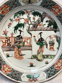 A pair of Chinese famille verte 'Ladies in a Garden' plates, Kangxi