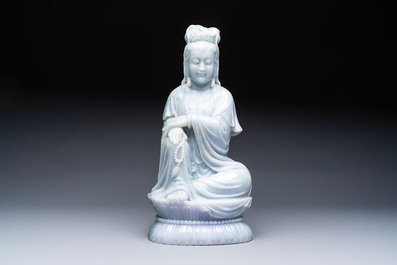 An exceptional and large Chinese carved pale lavender jadeite Guanyin on a wooden stand, Republic