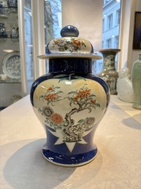 Two Chinese famille verte blue-ground vases and covers, 19th C.