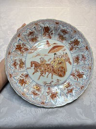A Chinese iron-red and gilt-decorated dish with a courtly carriage scene, Kangxi