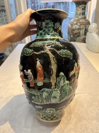 An unusual Chinese famille noire vase with relief design, Kangxi mark, 19th C.