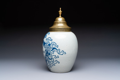 A blue and white Dutch Delft tobacco jar and a drug jar with brass lids, 18th C.