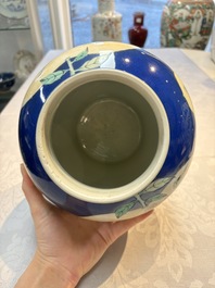 Two Chinese famille verte blue-ground vases and covers, 19th C.