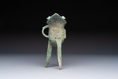 A Chinese archaic bronze wine vessel with Taotie design, Jue 爵, late Shang