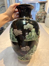 An unusual Chinese famille noire vase with relief design, Kangxi mark, 19th C.