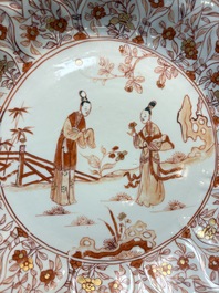A pair of Chinese iron-red and gilt-decorated 'Elegant Beauties in a Garden' dishes, Kangxi
