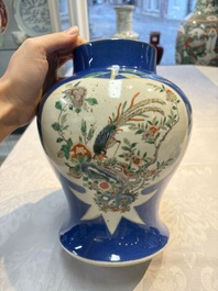 Two Chinese famille verte blue-ground vases and covers, 19th C.