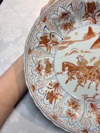 A Chinese iron-red and gilt-decorated dish with a courtly carriage scene, Kangxi