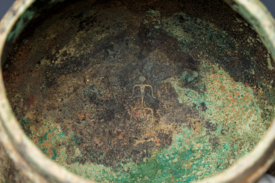 A Chinese archaic bronze wine vessel and cover with Taotie design, You 卣, late Shang