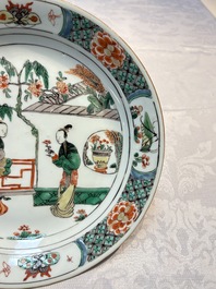 A pair of Chinese famille verte 'Ladies in a Garden' plates, Kangxi