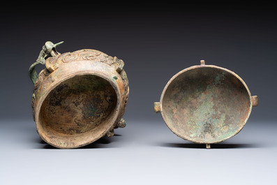 A Chinese archaic bronze wine vessel and cover with Taotie design, You 卣, late Shang