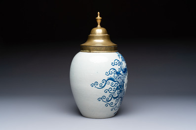 A blue and white Dutch Delft tobacco jar and a drug jar with brass lids, 18th C.
