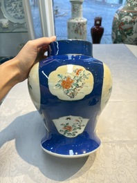 Two Chinese famille verte blue-ground vases and covers, 19th C.