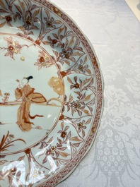 A pair of Chinese iron-red and gilt-decorated 'Elegant Beauties in a Garden' dishes, Kangxi