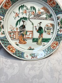 A pair of Chinese famille verte 'Ladies in a Garden' plates, Kangxi