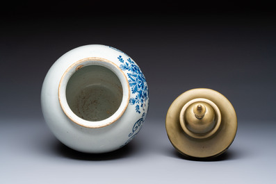A blue and white Dutch Delft tobacco jar and a drug jar with brass lids, 18th C.