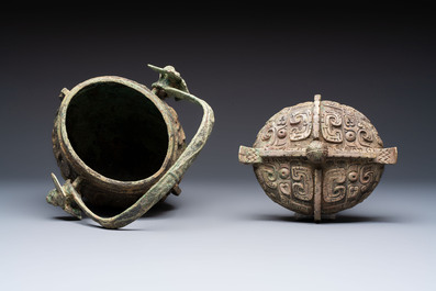 A Chinese archaic bronze wine vessel and cover with Taotie design, You 卣, late Shang
