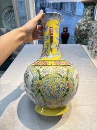 A Chinese famille rose yellow-ground &lsquo;Bats and Peaches&rsquo; bottle vase, Jiaqing/Daoguang