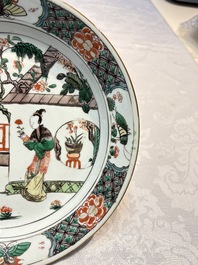 A pair of Chinese famille verte 'Ladies in a Garden' plates, Kangxi