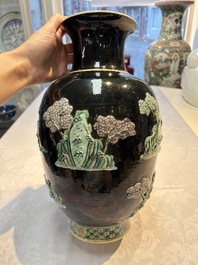 An unusual Chinese famille noire vase with relief design, Kangxi mark, 19th C.