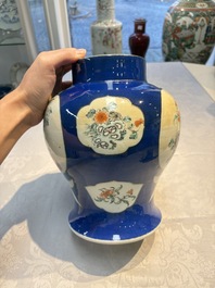 Two Chinese famille verte blue-ground vases and covers, 19th C.