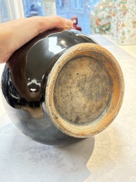 A Chinese black-glazed reverse-decorated bottle vase, 20th C.