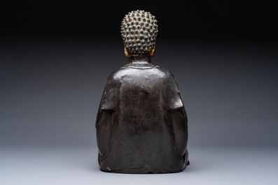 A large Chinese gilt-lacquered bronze Buddha, 17th C.