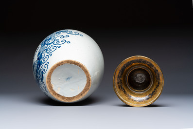 A blue and white Dutch Delft tobacco jar and a drug jar with brass lids, 18th C.