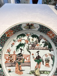 A pair of Chinese famille verte 'Ladies in a Garden' plates, Kangxi