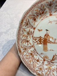 A pair of Chinese iron-red and gilt-decorated 'Elegant Beauties in a Garden' dishes, Kangxi
