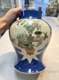 Two Chinese famille verte blue-ground vases and covers, 19th C.