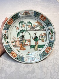 A pair of Chinese famille verte 'Ladies in a Garden' plates, Kangxi