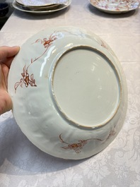 A pair of Chinese iron-red and gilt-decorated 'Elegant Beauties in a Garden' dishes, Kangxi
