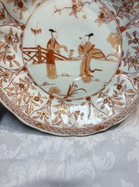 A pair of Chinese iron-red and gilt-decorated 'Elegant Beauties in a Garden' dishes, Kangxi