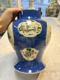 Two Chinese famille verte blue-ground vases and covers, 19th C.