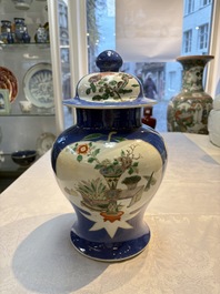 Two Chinese famille verte blue-ground vases and covers, 19th C.