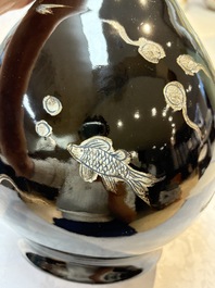 A Chinese black-glazed reverse-decorated bottle vase, 20th C.