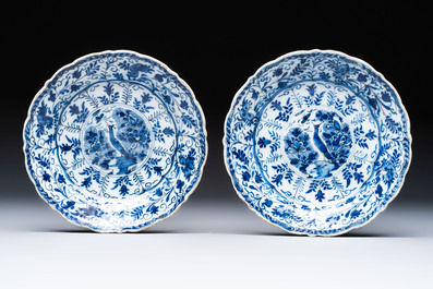 A pair of blue and white Dutch Delft 'Cranes' plates and a dish, 18th C.