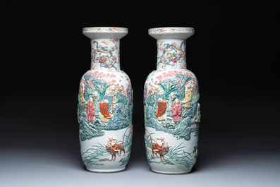 A pair of Chinese famille rose '18 Luohan' vases with relief design, 19th C.