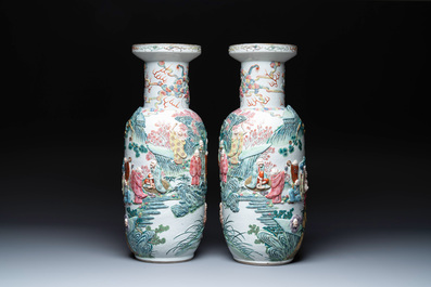 A pair of Chinese famille rose '18 Luohan' vases with relief design, 19th C.