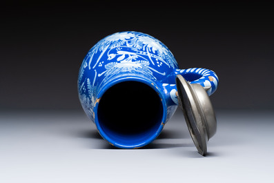 A Nevers white-decorated Persian-blue-ground faience jug with a mounted pewter lid, France, 18th C.