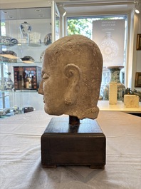 A Chinese sandstone head of a Luohan, early Qing