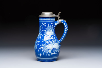 A Nevers white-decorated Persian-blue-ground faience jug with a mounted pewter lid, France, 18th C.